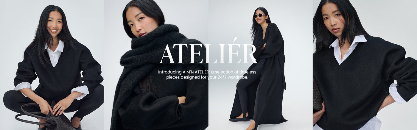 Modell bär AIM’N ATELIÉR-kollektion över vit skjorta